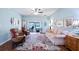 Comfortable living room boasts large windows, a ceiling fan, and stylish decor at 4671 Spring Grove Ln, Leesburg, FL 34748