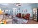 Comfortable living room boasts large windows, a ceiling fan, and stylish decor at 4671 Spring Grove Ln, Leesburg, FL 34748