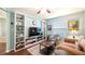 Inviting living room boasts custom built-ins, a ceiling fan, and comfortable seating, creating a cozy and stylish space at 4671 Spring Grove Ln, Leesburg, FL 34748