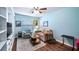 Inviting living room with plush seating, a ceiling fan, and ample natural light creating a relaxing space at 4671 Spring Grove Ln, Leesburg, FL 34748