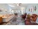 Bright living room with a ceiling fan, comfortable furniture, and stylish decor at 4671 Spring Grove Ln, Leesburg, FL 34748