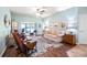 Cozy living room features a sliding glass door to a patio and comfortable seating at 4671 Spring Grove Ln, Leesburg, FL 34748