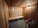Relaxing sauna with wood paneling, built-in bench, and traditional sauna accessories for a spa-like experience at 4671 Spring Grove Ln, Leesburg, FL 34748