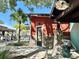 Charming spa entrance featuring stone accents, signage, and a welcoming outdoor area with lush landscaping at 4671 Spring Grove Ln, Leesburg, FL 34748