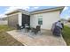 A charming backyard features a cozy patio seating area and well-maintained landscaping at 488 Avila Pl, Howey In The Hills, FL 34737