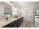 Elegant bathroom with dual sinks, sleek black fixtures, and a glass-enclosed shower at 488 Avila Pl, Howey In The Hills, FL 34737