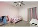 Charming bedroom with a ceiling fan, unicorn bedding, and decorative wall accents at 488 Avila Pl, Howey In The Hills, FL 34737