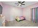 Comfortable bedroom features a ceiling fan, plush carpet, and pastel-colored walls at 488 Avila Pl, Howey In The Hills, FL 34737