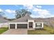 Charming one-story home with a three-car garage, manicured lawn, and a welcoming front entrance at 488 Avila Pl, Howey In The Hills, FL 34737