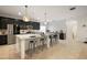 Kitchen features an island with bar stool seating, modern appliances, pendant lighting, and a pantry at 488 Avila Pl, Howey In The Hills, FL 34737