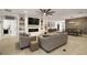 Inviting living room featuring a modern fireplace, built-in shelves, and seamless flow to the dining area at 488 Avila Pl, Howey In The Hills, FL 34737