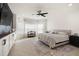 Light-filled main bedroom featuring a ceiling fan, a sitting area, and stylish decor at 488 Avila Pl, Howey In The Hills, FL 34737