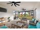 Spacious screened patio with comfortable seating and views of the backyard and playset at 488 Avila Pl, Howey In The Hills, FL 34737