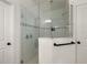 Modern glass enclosed shower features sleek black hardware and tiled walls at 488 Avila Pl, Howey In The Hills, FL 34737