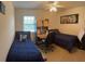 Bedroom featuring two twin beds, ceiling fan and a study desk at 4941 Tradition Dr, Lakeland, FL 33812
