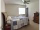 Cozy bedroom with a comfortable bed, side table, and dresser at 4941 Tradition Dr, Lakeland, FL 33812
