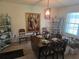 Cozy dining room featuring a classic chandelier, dark wood table set for six, and decorative shelving at 4941 Tradition Dr, Lakeland, FL 33812