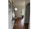 Inviting foyer with hardwood floors, decorative wall hangings, and a view to the front door at 4941 Tradition Dr, Lakeland, FL 33812