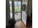 Inviting front door with a decorative wreath, wood floors, and a glimpse of the well-maintained front yard at 4941 Tradition Dr, Lakeland, FL 33812