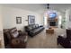 Open-concept living room with a stone fireplace, vaulted ceiling, and comfortable seating arrangements at 4941 Tradition Dr, Lakeland, FL 33812