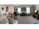 Spacious living room featuring a comfortable seating arrangement and large windows that provide ample natural light at 4941 Tradition Dr, Lakeland, FL 33812