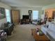 Bright living room with comfortable seating, neutral carpet, and large windows, creating a welcoming atmosphere at 4941 Tradition Dr, Lakeland, FL 33812