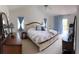 Spacious main bedroom with a king bed, carpet, curtains, and access to the deck at 4941 Tradition Dr, Lakeland, FL 33812