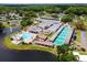 Aerial of recreational facility featuring swimming pool, shuffleboard courts, and clubhouse at 504 Hawthorne Blvd, Leesburg, FL 34748