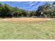 Well maintained community baseball field with grassy outfield, covered benches, and clay infield at 504 Hawthorne Blvd, Leesburg, FL 34748