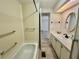 Bright bathroom featuring a tub-shower combination and single sink vanity with ample countertop space at 504 Hawthorne Blvd, Leesburg, FL 34748