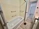 Well-maintained bathtub and shower area features wall-mounted towel bars and neutral wall colors at 504 Hawthorne Blvd, Leesburg, FL 34748