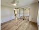 Bedroom featuring a sliding mirrored closet and light wood floors at 504 Hawthorne Blvd, Leesburg, FL 34748