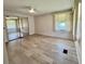 Bright bedroom with wood-look flooring, mirrored closet doors, and natural light from a large window at 504 Hawthorne Blvd, Leesburg, FL 34748