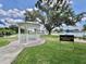 Celebration Square gazebo offering a tranquil lakeside setting with lush landscaping at 504 Hawthorne Blvd, Leesburg, FL 34748