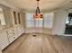 Cozy dining area with a beautiful light fixture and plenty of natural light at 504 Hawthorne Blvd, Leesburg, FL 34748