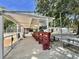 Covered baseball dugout with benches, fans, and concrete flooring at 504 Hawthorne Blvd, Leesburg, FL 34748
