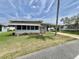 A cozy single-story home with a large window area is accented by a perfectly manicured lawn at 504 Hawthorne Blvd, Leesburg, FL 34748
