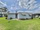 Charming single-story home with light blue siding, awning, and well-maintained lawn at 504 Hawthorne Blvd, Leesburg, FL 34748