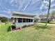 Exterior side view of a single-story home showing manicured flower beds and large window area at 504 Hawthorne Blvd, Leesburg, FL 34748