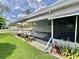 This charming home includes a cozy screened-in porch and landscaping around the home at 504 Hawthorne Blvd, Leesburg, FL 34748