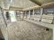 Enclosed Florida room with lots of natural light, screened windows, carpet flooring, and views of the community at 504 Hawthorne Blvd, Leesburg, FL 34748