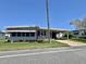 Charming single story home featuring a carport and manicured front lawn at 504 Hawthorne Blvd, Leesburg, FL 34748