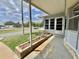 Cozy covered front porch with planters creates a welcoming entrance at 504 Hawthorne Blvd, Leesburg, FL 34748