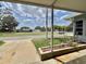 Covered front porch view overlooking the community and beautifully landscaped lawn at 504 Hawthorne Blvd, Leesburg, FL 34748