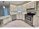Well-equipped kitchen features stainless steel appliances, white cabinets, and ample counter space at 504 Hawthorne Blvd, Leesburg, FL 34748
