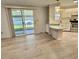 Bright living room with light wood flooring and access to the screened-in porch at 504 Hawthorne Blvd, Leesburg, FL 34748