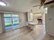 Open living space featuring a breakfast bar, and a sliding door leading to the sunroom at 504 Hawthorne Blvd, Leesburg, FL 34748