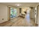 Bright and airy living room featuring modern flooring, kitchen bar, and access to sunroom at 504 Hawthorne Blvd, Leesburg, FL 34748