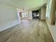 Open-concept living area with wood-look flooring, offering seamless transition between living room, dining and Florida room at 504 Hawthorne Blvd, Leesburg, FL 34748