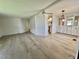 Open-concept living space with wood-look flooring, connecting the living room and dining area for easy flow at 504 Hawthorne Blvd, Leesburg, FL 34748